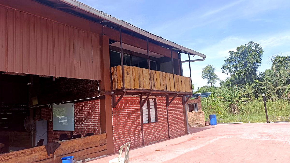 The village building and courtyard by day